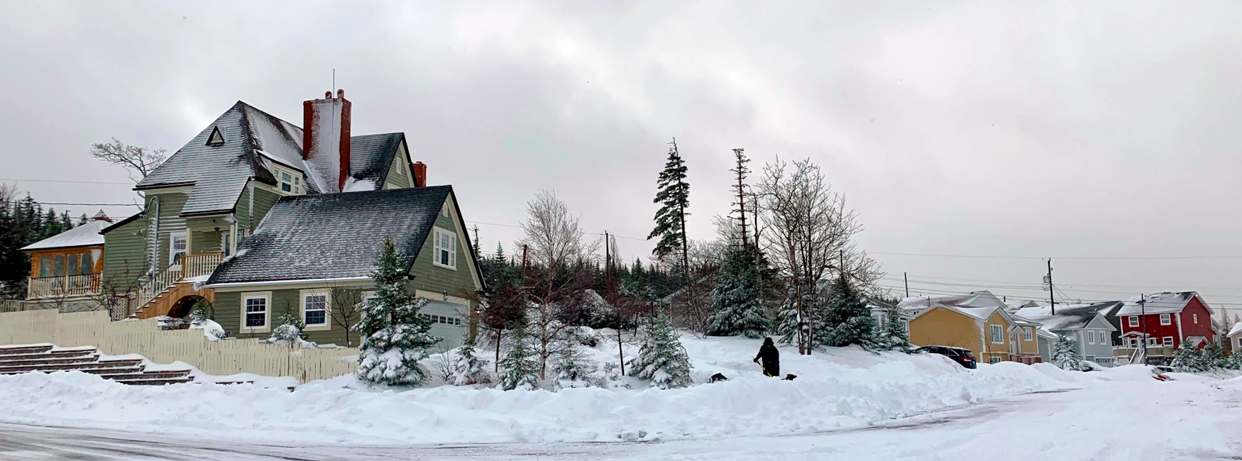 Snowy residential street in Airport Heights, St. John's, featuring houses and snow-covered trees.